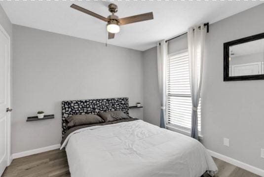 bedroom with hardwood / wood-style flooring and ceiling fan