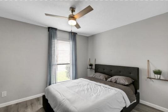 bedroom with ceiling fan and wood-type flooring