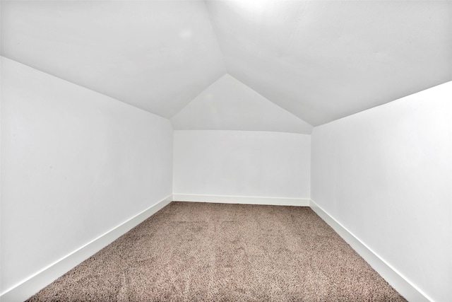 bonus room featuring lofted ceiling and carpet flooring