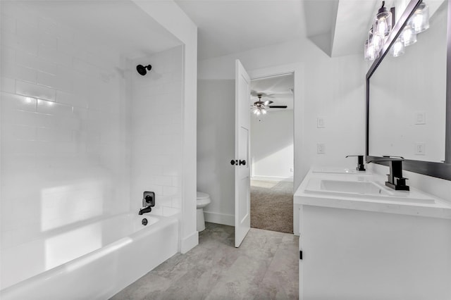 full bathroom with tiled shower / bath, vanity, ceiling fan, and toilet