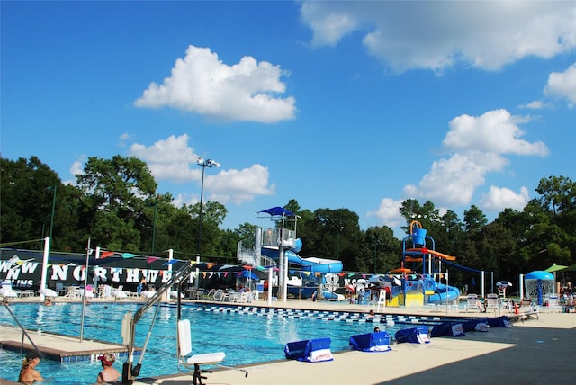 17207 Hill View Ln, Spring, TX 77379 - community pool featuring a water slide and view of scattered trees