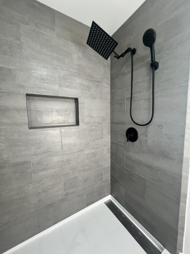 bathroom with a tile shower