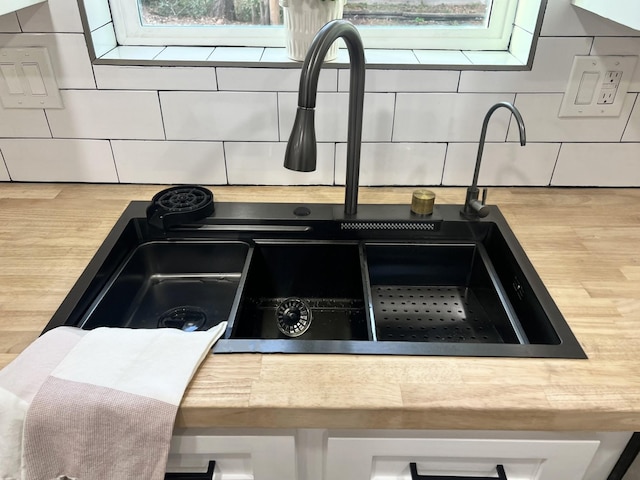 room details featuring sink and decorative backsplash