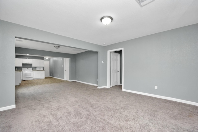 unfurnished living room with light colored carpet