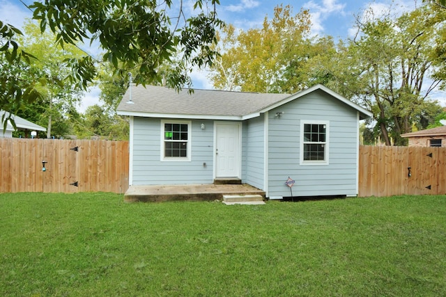 back of house with a yard