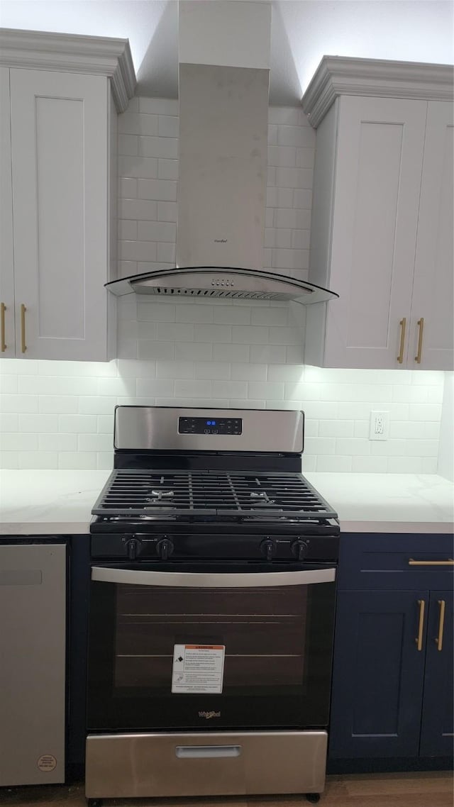 kitchen with stainless steel appliances, tasteful backsplash, and white cabinets