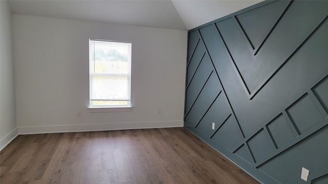 empty room with lofted ceiling and light hardwood / wood-style floors