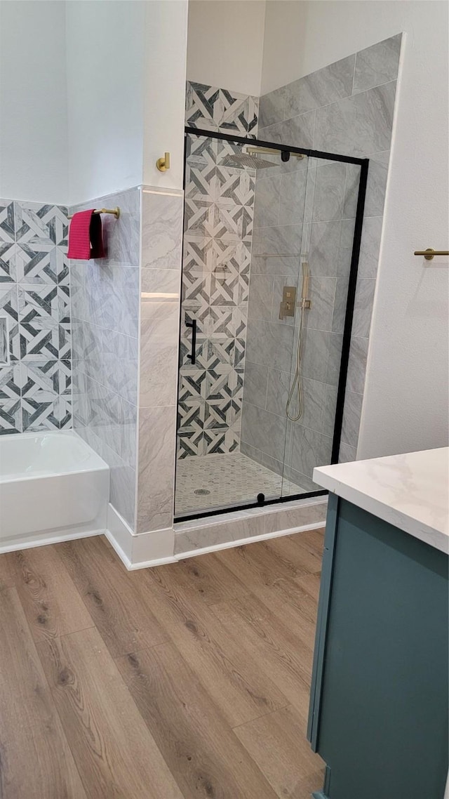 bathroom featuring vanity, hardwood / wood-style floors, and independent shower and bath