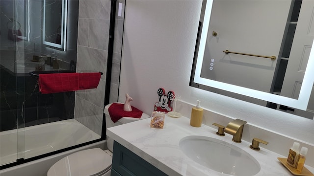 full bathroom with toilet, vanity, and shower / bath combination with glass door