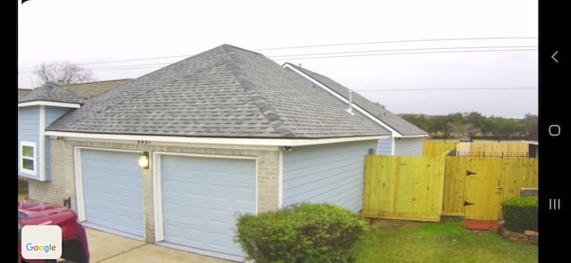 view of side of property featuring a garage and an outbuilding