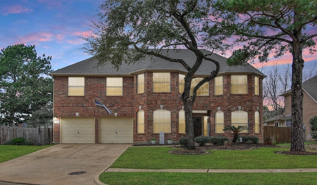 view of front of property featuring a garage and a yard