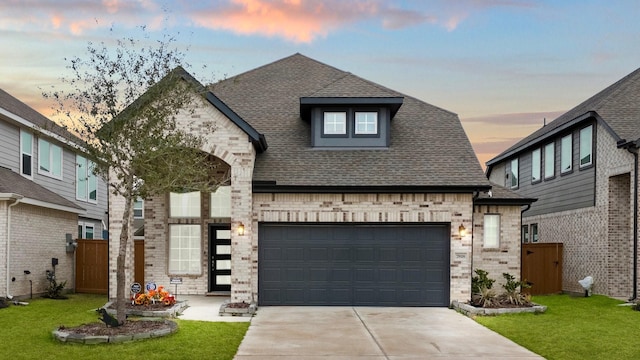 view of front facade featuring a garage and a lawn