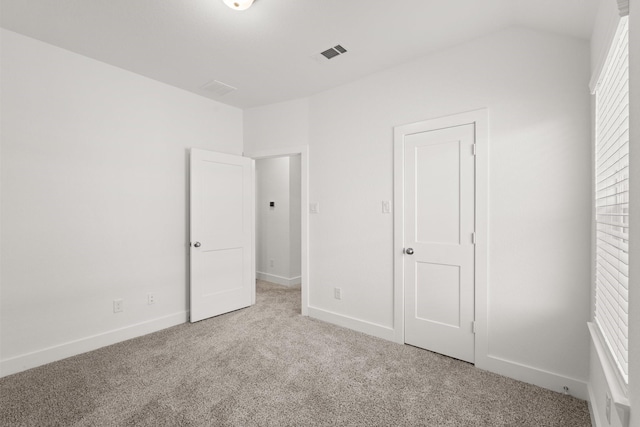 unfurnished bedroom with light colored carpet