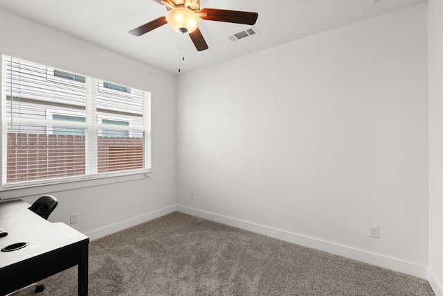 unfurnished office featuring ceiling fan and carpet flooring