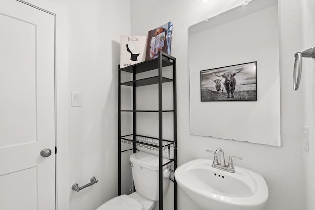 bathroom with sink and toilet