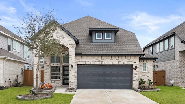 view of front facade with a garage and a front yard