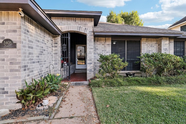 doorway to property with a lawn