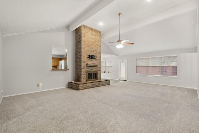 unfurnished living room featuring lofted ceiling with beams, a brick fireplace, carpet, and ceiling fan