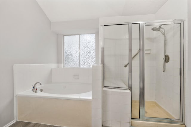 bathroom featuring independent shower and bath and hardwood / wood-style floors