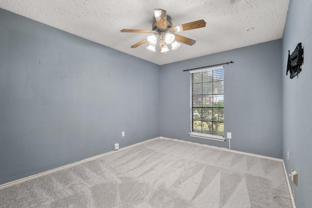 carpeted empty room with ceiling fan and a textured ceiling