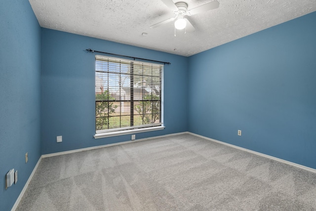 unfurnished room with ceiling fan, carpet flooring, and a textured ceiling