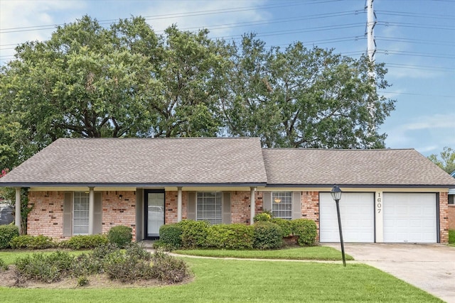 ranch-style house featuring a garage and a front lawn