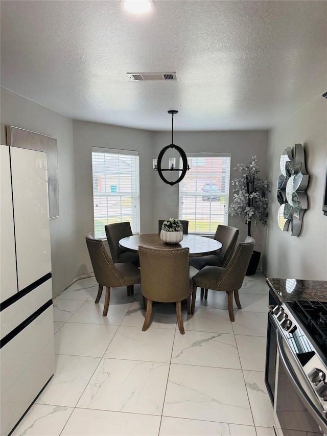 dining room with a textured ceiling