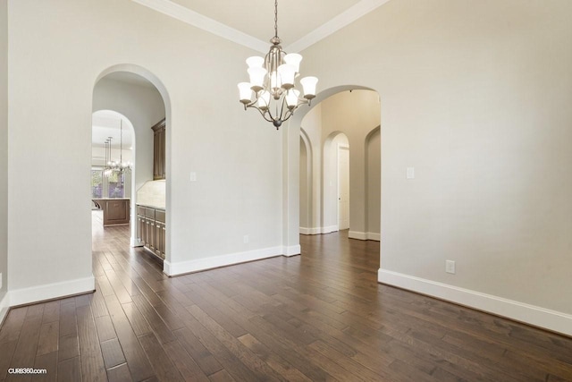 unfurnished dining area with crown molding, a notable chandelier, and dark hardwood / wood-style flooring