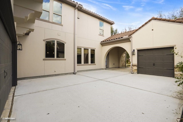 rear view of house featuring a garage