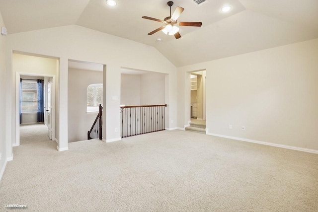 carpeted empty room with ceiling fan and vaulted ceiling