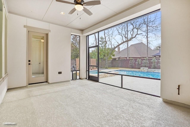 interior space with ceiling fan