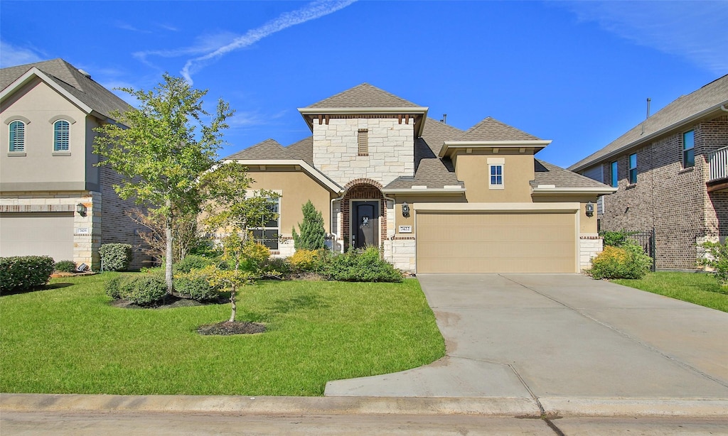 view of front of house with a garage and a front lawn