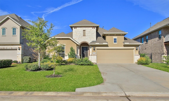 view of front of house with a garage and a front lawn