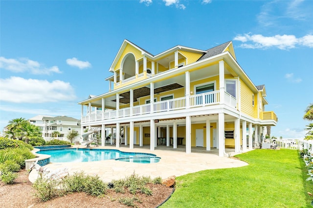 back of property featuring a patio, a balcony, a yard, and ceiling fan