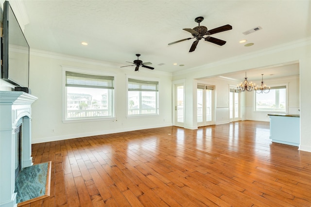 unfurnished living room with crown molding, light hardwood / wood-style flooring, and ceiling fan with notable chandelier