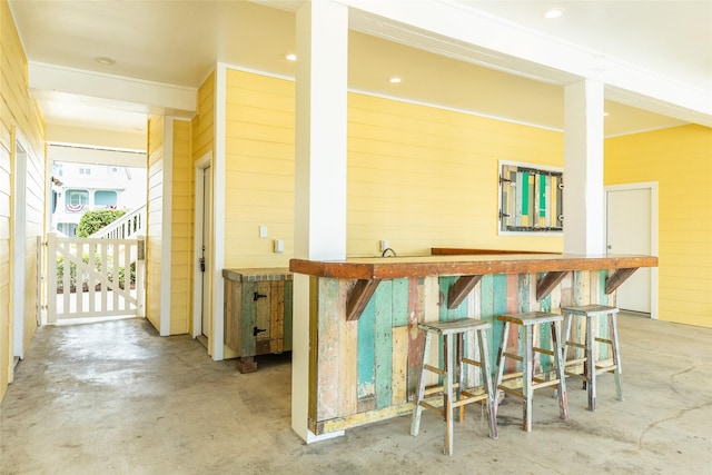 kitchen with a kitchen bar and wood walls