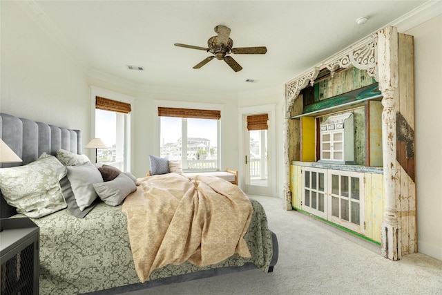 carpeted bedroom with crown molding, ceiling fan, multiple windows, and access to outside