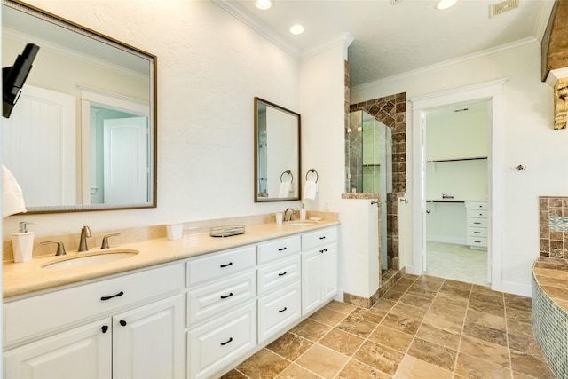 bathroom with vanity, ornamental molding, and walk in shower