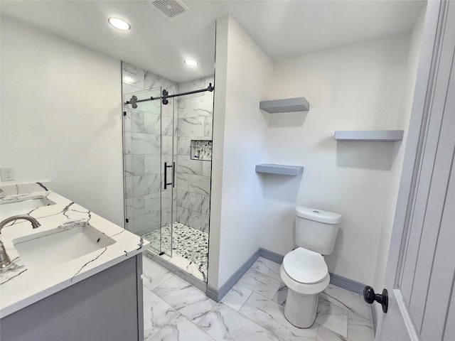 bathroom with vanity, a shower with door, and toilet