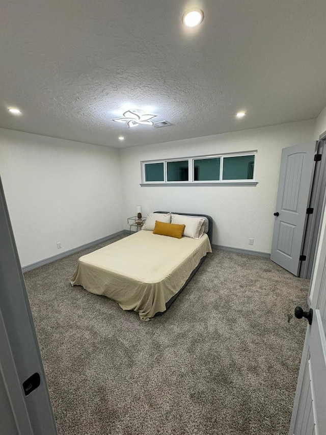 carpeted bedroom with a textured ceiling