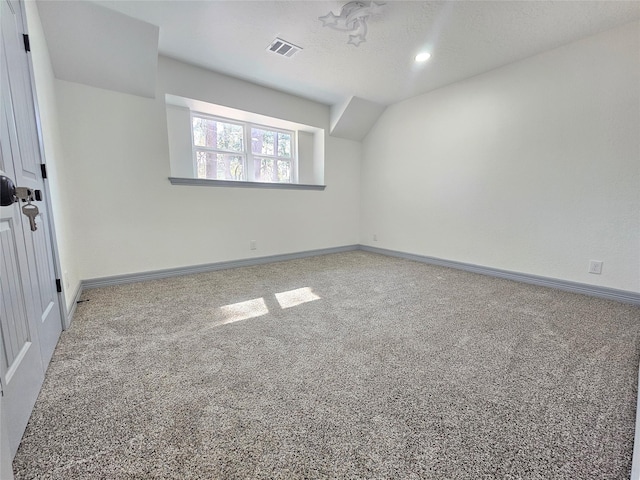 carpeted spare room with a textured ceiling