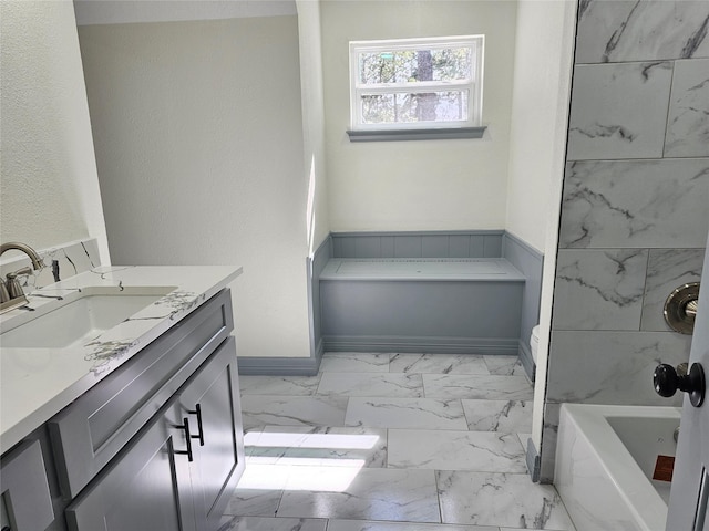 bathroom featuring vanity and a tub