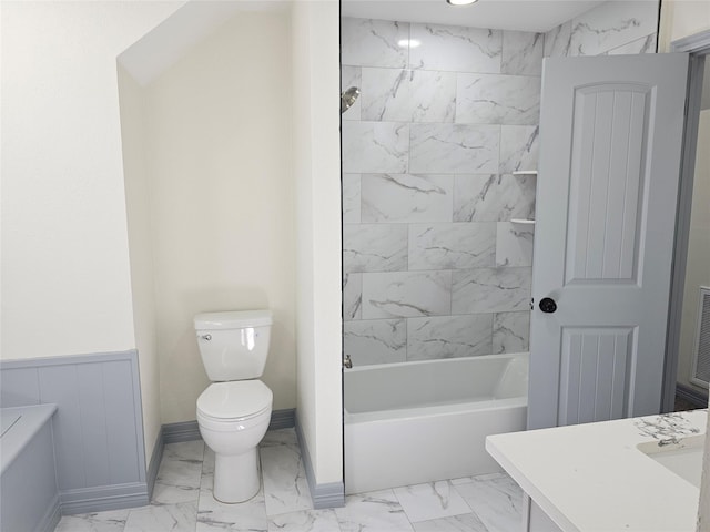 full bathroom featuring vanity, toilet, and tiled shower / bath combo