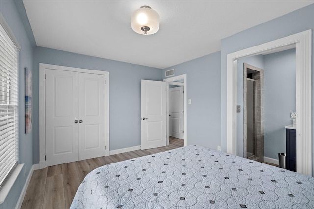 bedroom featuring a closet and light hardwood / wood-style flooring