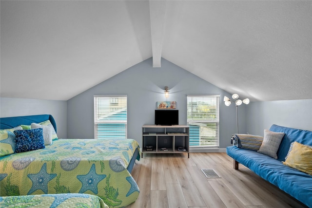 bedroom with lofted ceiling and light hardwood / wood-style floors