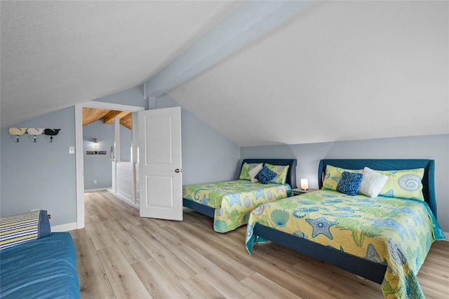 bedroom with light hardwood / wood-style flooring and lofted ceiling with beams