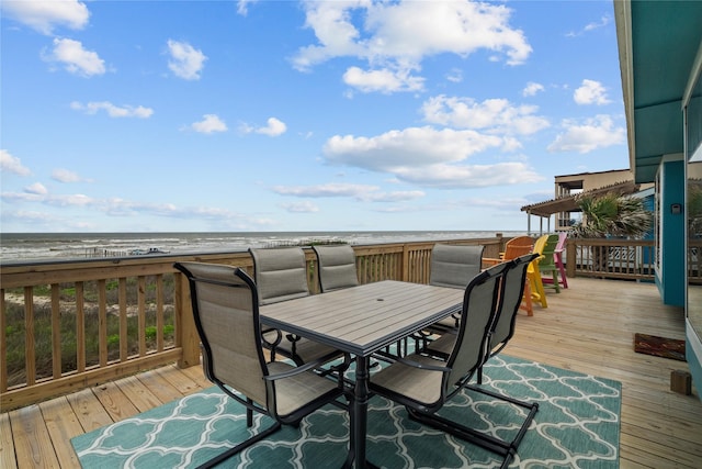 wooden deck featuring a view of the beach and a water view