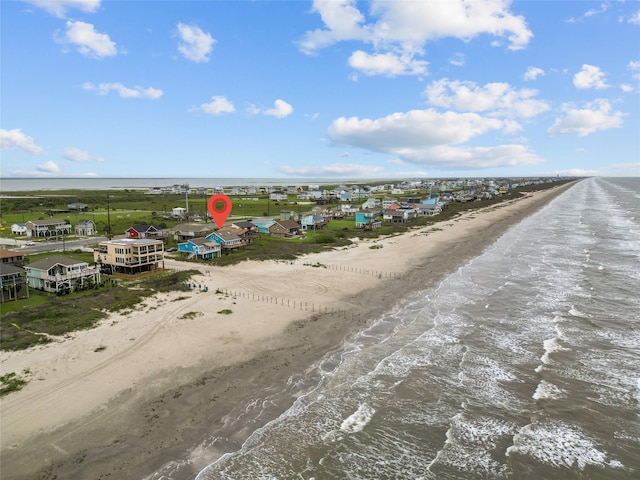 drone / aerial view with a water view and a beach view