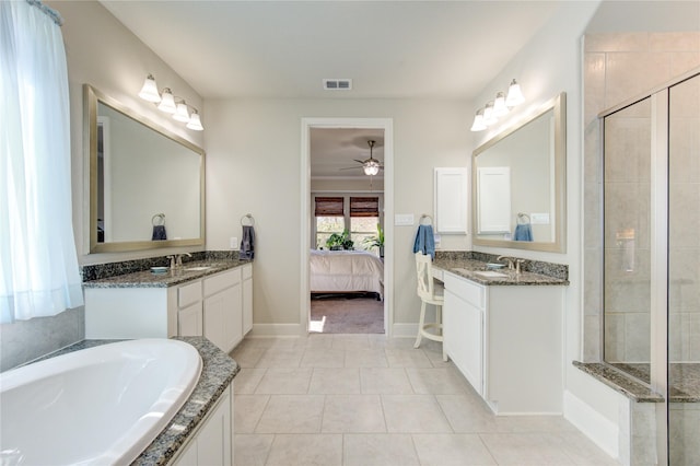 ensuite bathroom featuring tile patterned flooring, visible vents, connected bathroom, and a sink