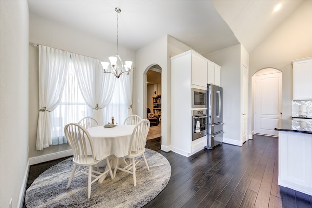 dining space with arched walkways, lofted ceiling, baseboards, dark wood-style floors, and an inviting chandelier